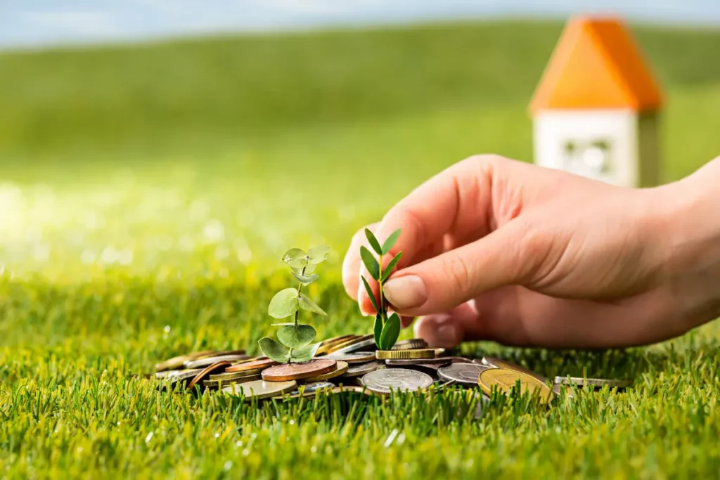 An illustration of stalled energy transition due to lack of funding. A hand planting small plants on a pile of coins symbolizes the hope for green investment that has yet to materialize. The failure of Just Energy Transition Partnership (JETP) funding complicates Indonesia’s energy transition efforts.