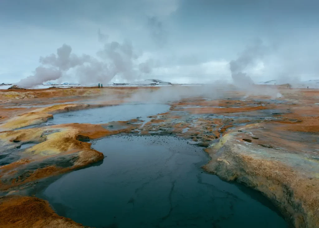 Steam rising from geothermal hot springs in a volcanic landscape—illustrating the natural geothermal potential that countries like Indonesia aim to harness through effective public-private partnerships (PPPs).